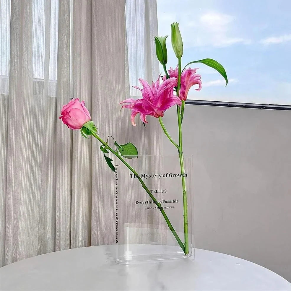 Transparent book-shaped acrylic vase, 22cm long with black font, refracting sunlight for home decor