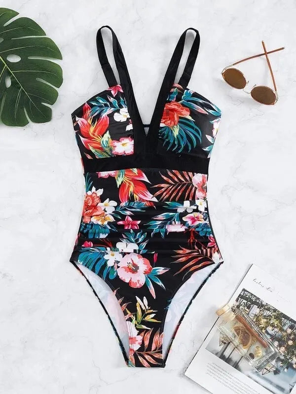 Women's floral pattern backless one-piece swimsuit on a hanger.