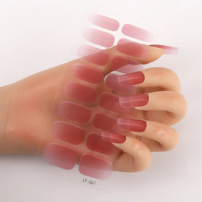 Sheet of 16 small design nail art stickers including cross, rose, tulip and marble patterns.