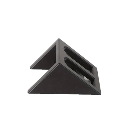 Matte black plastic punk-style pistol display stand on a wooden surface, measuring 10.85cm long.