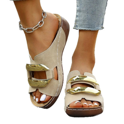 Roman style platform sandals in black with a flat heel and metal detail on the strap.