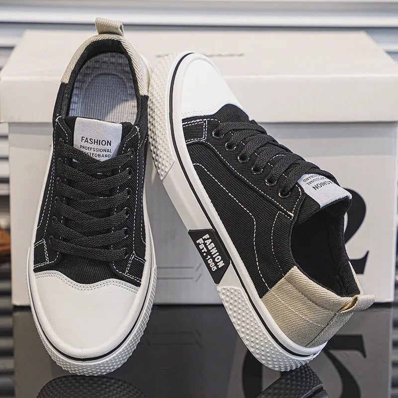 Men's low-top blue canvas skate shoes with round toe and flat heel on a white background.