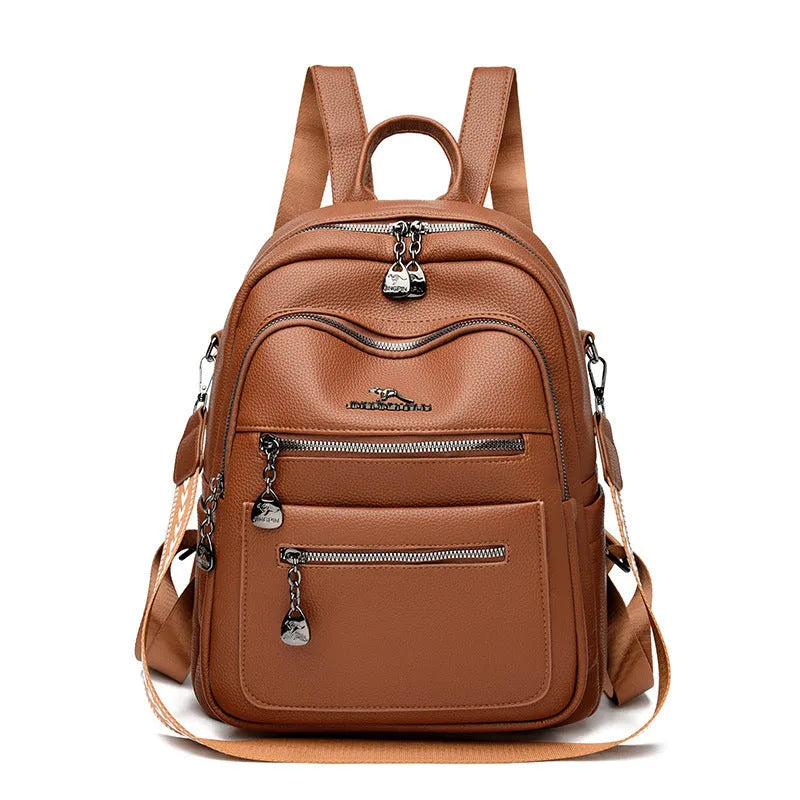 Genuine leather multi-functional commuting backpack with flap pocket, polyester lining, and metal letter patchwork details in black.