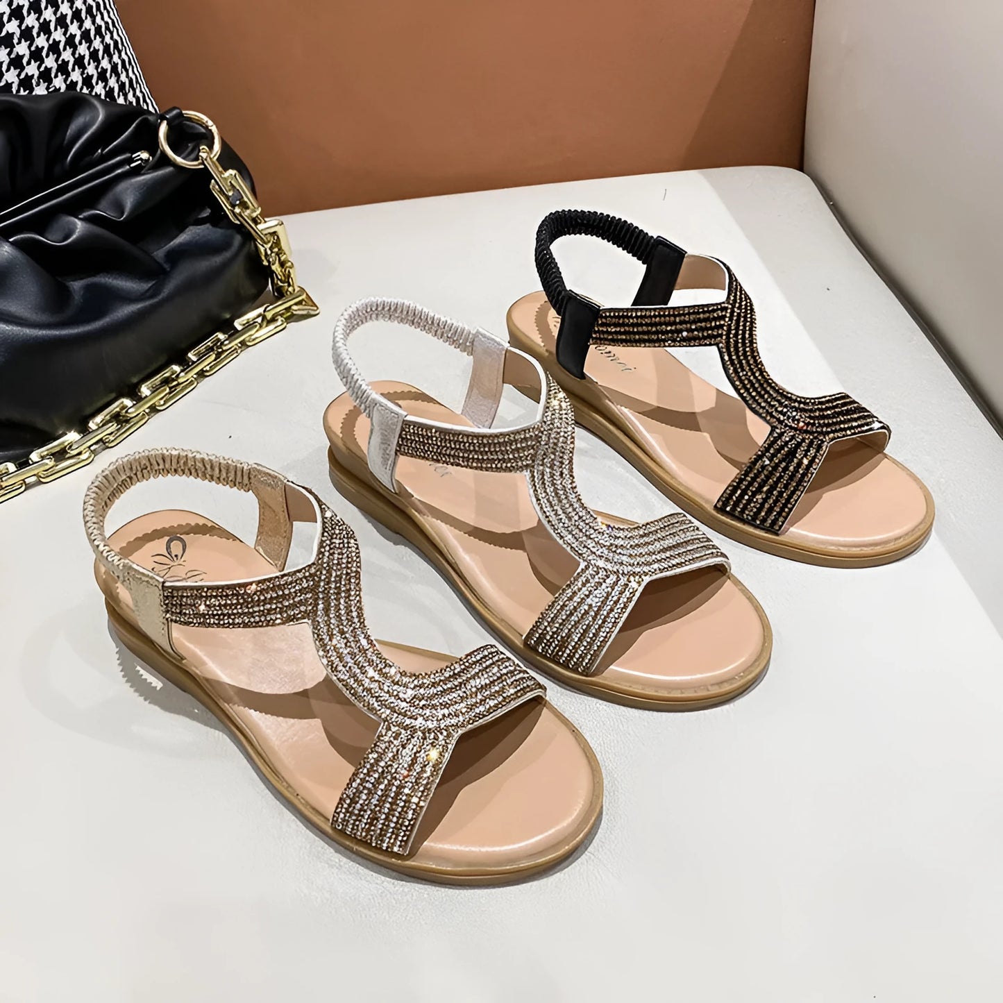 Gold patent leather women's sandals with rhinestone decoration on the strap.