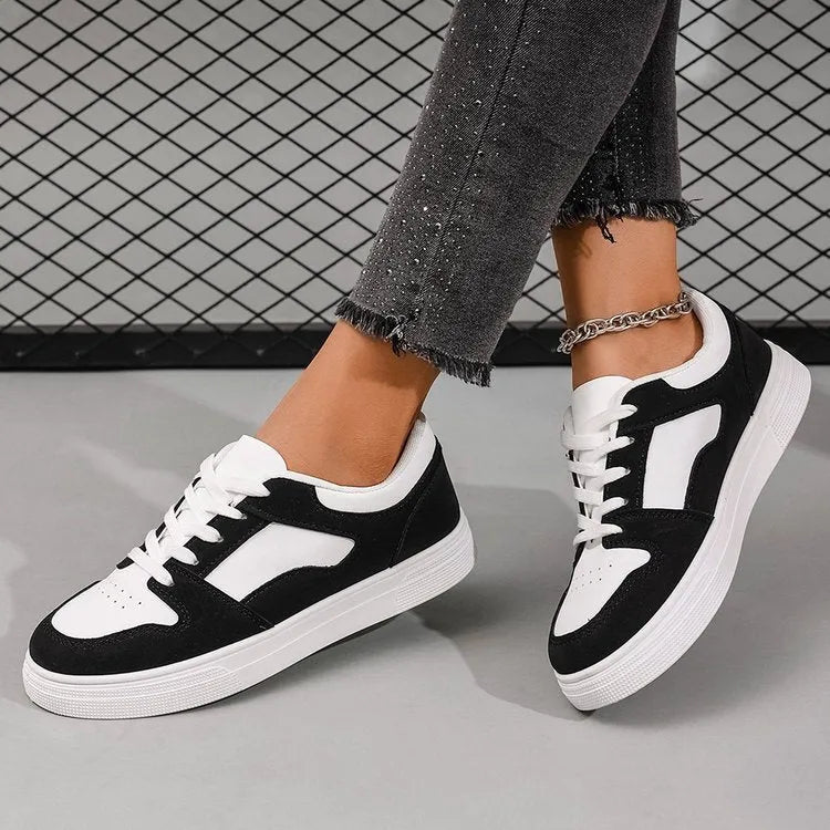Black women's low-top lace-up casual sports shoes with a round toe and flat rubber sole.