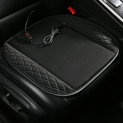 USB ventilated car seat cushion in black suede material with cable, placed on a car seat.