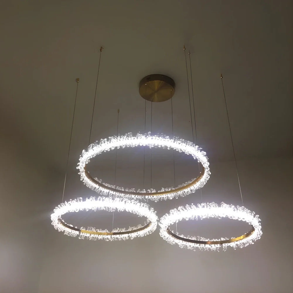 Gold electroplated crystal chandelier with remote control, adjustable height mechanism, and multiple LED lights
