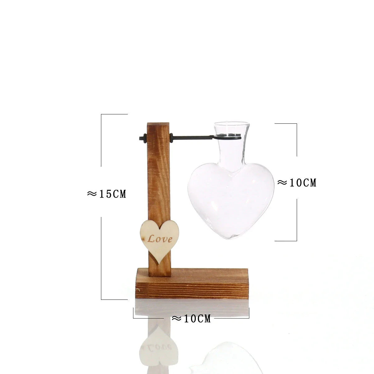 Elegant heart-shaped glass terrarium with wooden stand, showcasing a natural, minimalist design perfect for indoor plant display or decorative accents.