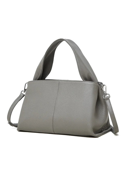 Women's genuine cowhide retro texture messenger bag in horizontal square shape, shown in apricot colour with double shoulder straps.