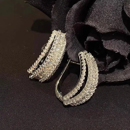 Women's white gold geometry stud earrings with inlaid zircon detail on copper.