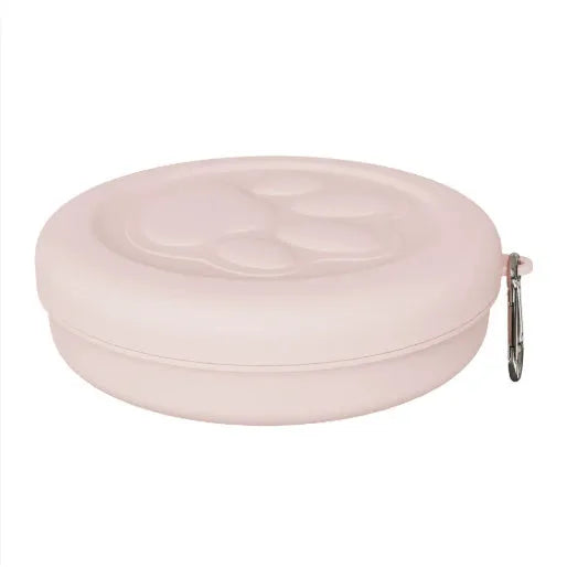 Collapsible silicone dog bowl with integrated snack compartment in light pink colour