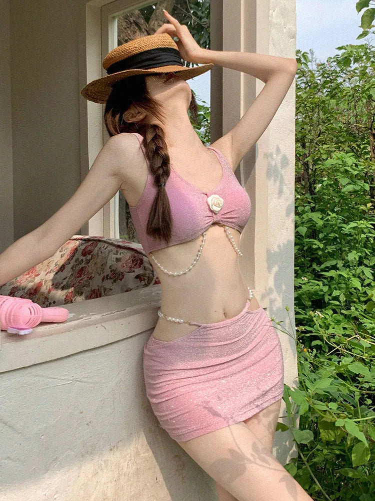 Pink and black three-piece bikini set with briefs style and sleeveless design for swimming.