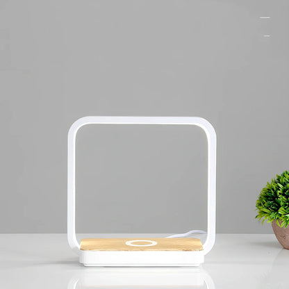 Modern bedside lamp with wireless charging pad and adjustable LED lighting in gold finish