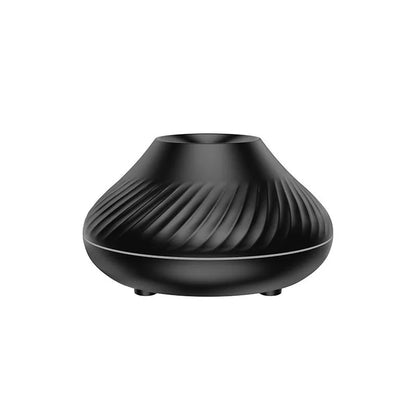 Beige volcanic flame aroma diffuser with LED lighting and mist output on wooden surface