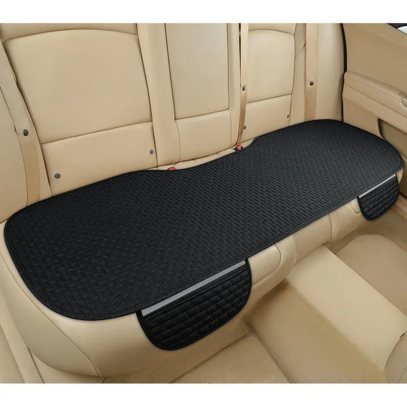 Linen car cushion with plaid pattern in cream colour on automotive seat