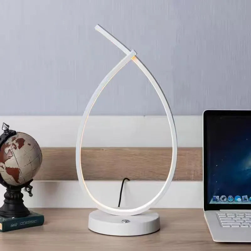 Black or white water drop shaped USB table lamp with touch control measuring 30cm tall