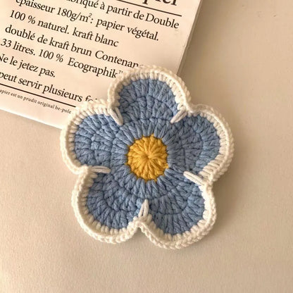Five handmade woven flower placemats in blue, green, orange, pink and purple colours