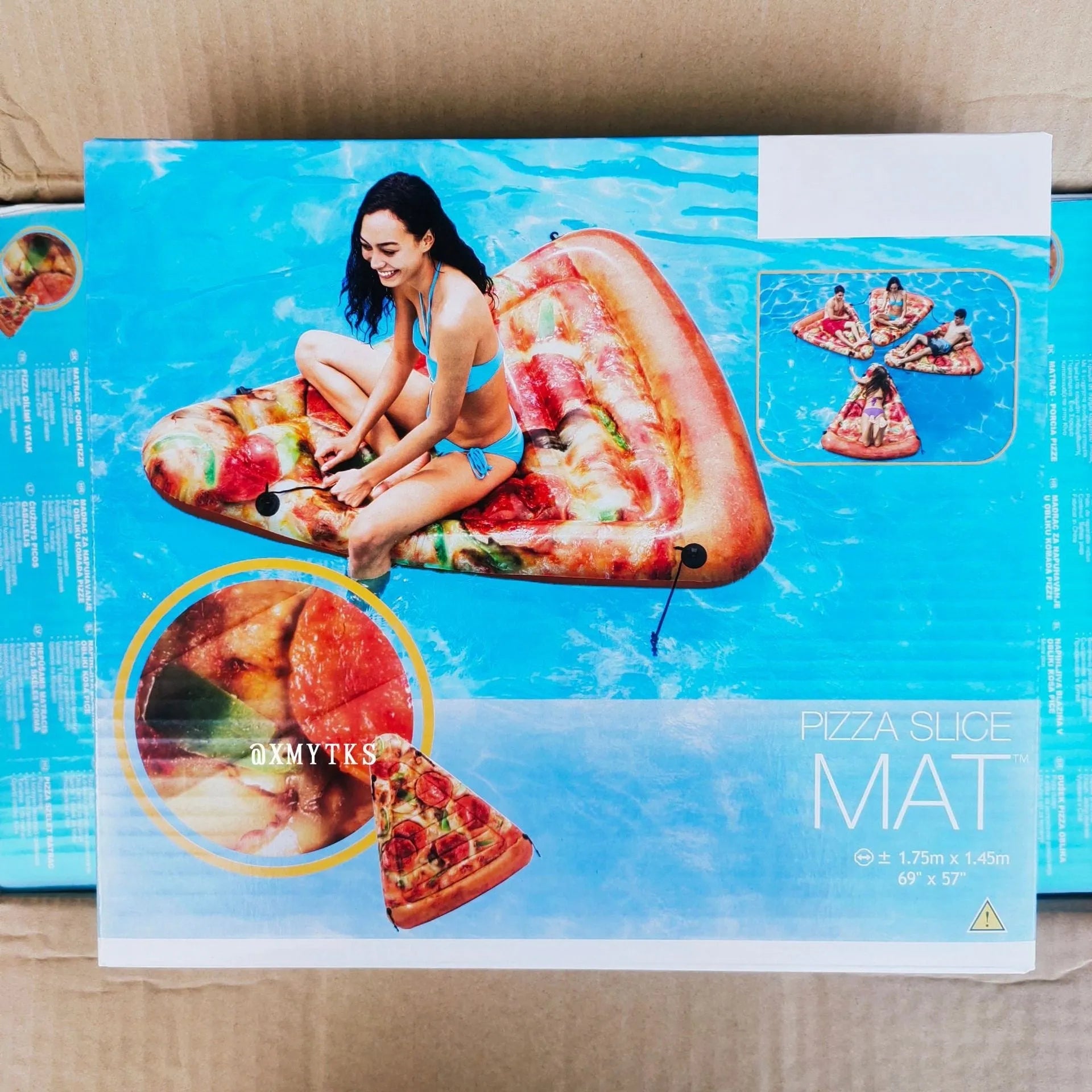 Large inflatable pizza surfboard recliner floating in a swimming pool.