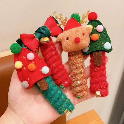 Festive Christmas hair ties with various holiday-themed designs, including red bells, green Christmas trees, and khaki deer shapes.