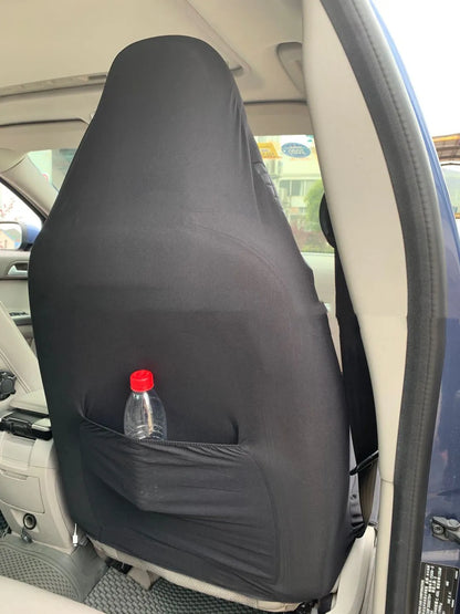 Black quilted universal car seat cover fitted on a front car seat, showing diamond stitching and plastic hook fastenings.