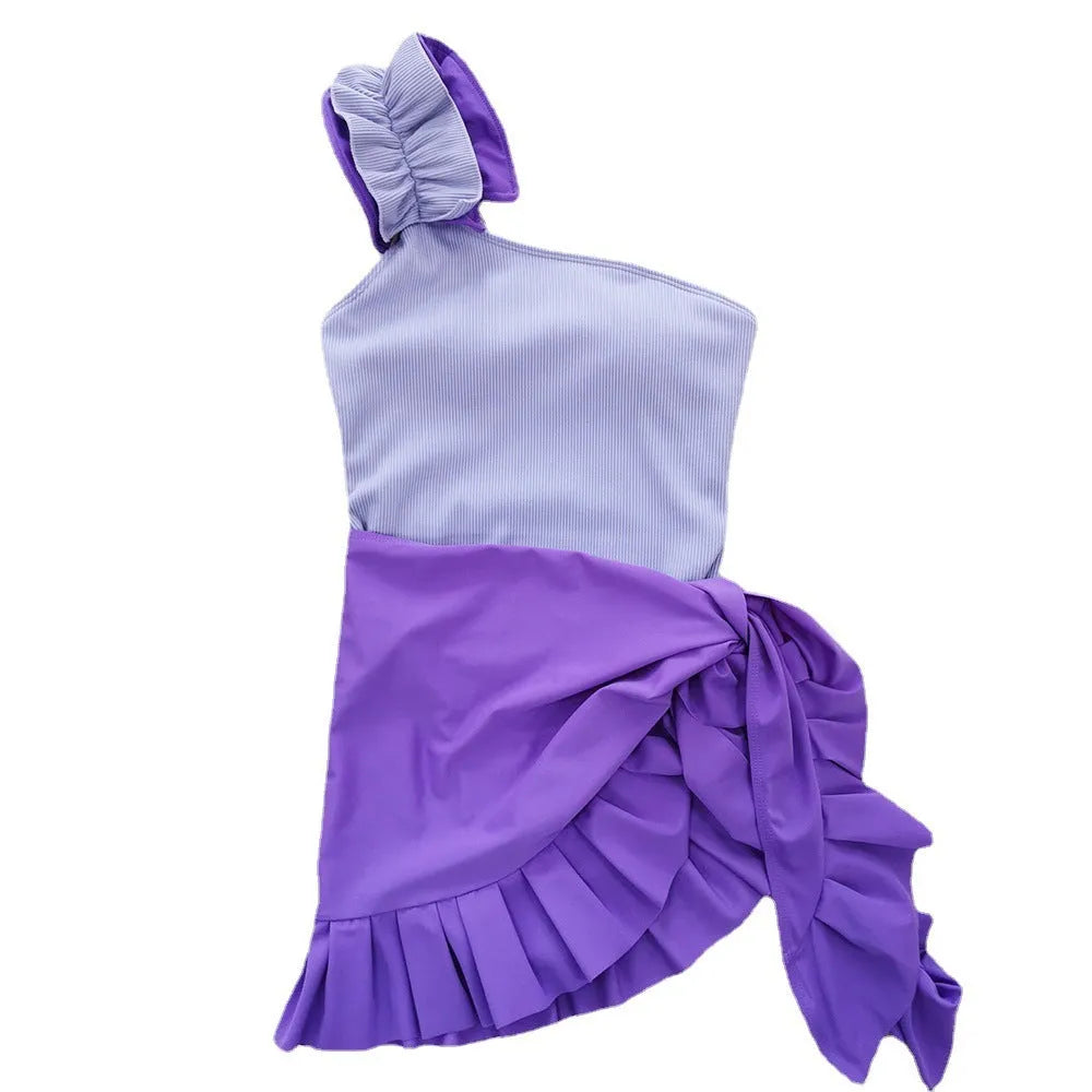 A woman's solid colour one-piece swimsuit with a single-shoulder suspender tube top design.