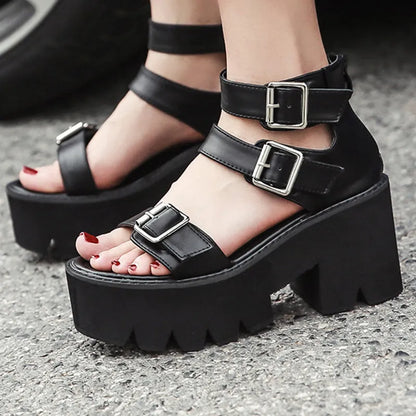 Black women's punk platform sandals with chunky heel, round toe, buckle detail, and back zipper.