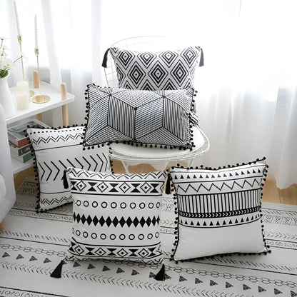 Bohemian style decorative pillowcase in light grey colour on a sofa.