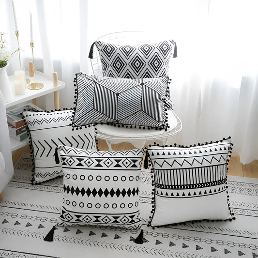 Bohemian style decorative pillowcase in light grey colour on a sofa.