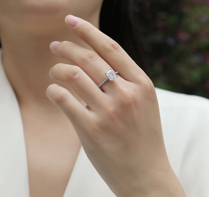 A wedding ring set featuring top-quality moissanite stones set in S925 silver with platinum plating, available in sizes 5-9 with a GRA certificate for authenticity verification using a diamond pen