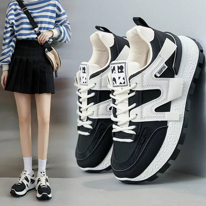Women's low-top running sneaker in white or black with rubber sole