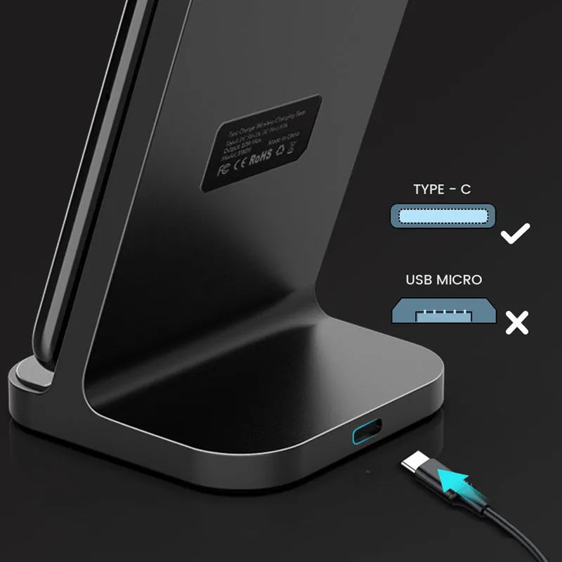 Dark grey vertical wireless charging stand for Apple iPhone on a desk.