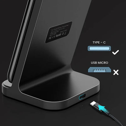 Dark grey vertical wireless charging stand for Apple iPhone on a desk.