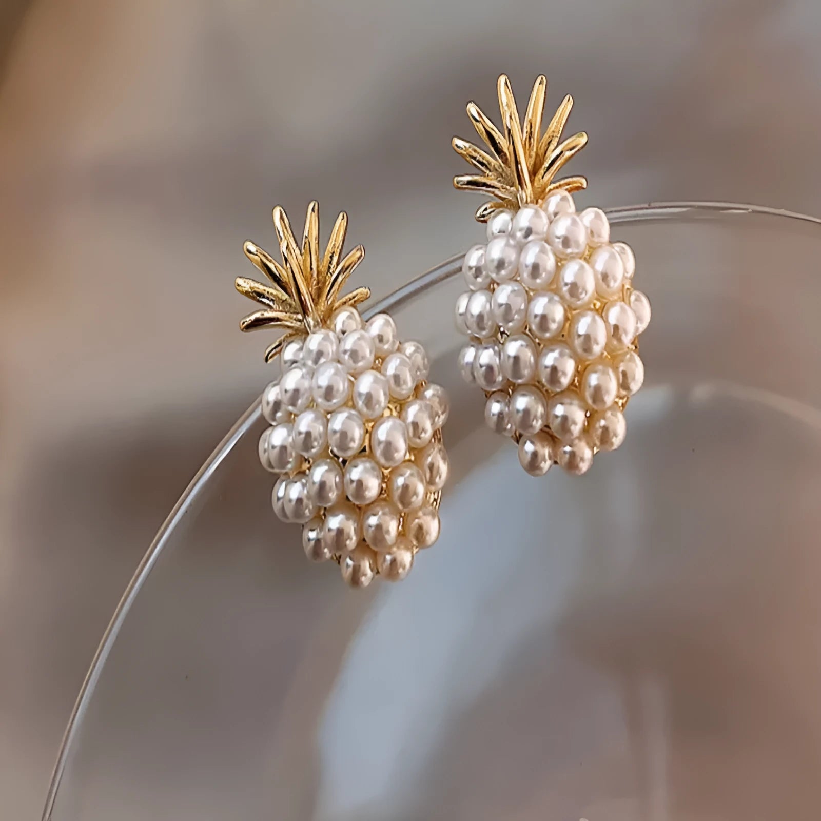Korean-style women's pineapple starfish pearl alloy earrings with gemstone details in gold, pearl flower, silver, and starfish pearl colours.