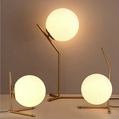 Clear glass spherical table lamp with aluminium base showing dual-colour LED lighting options