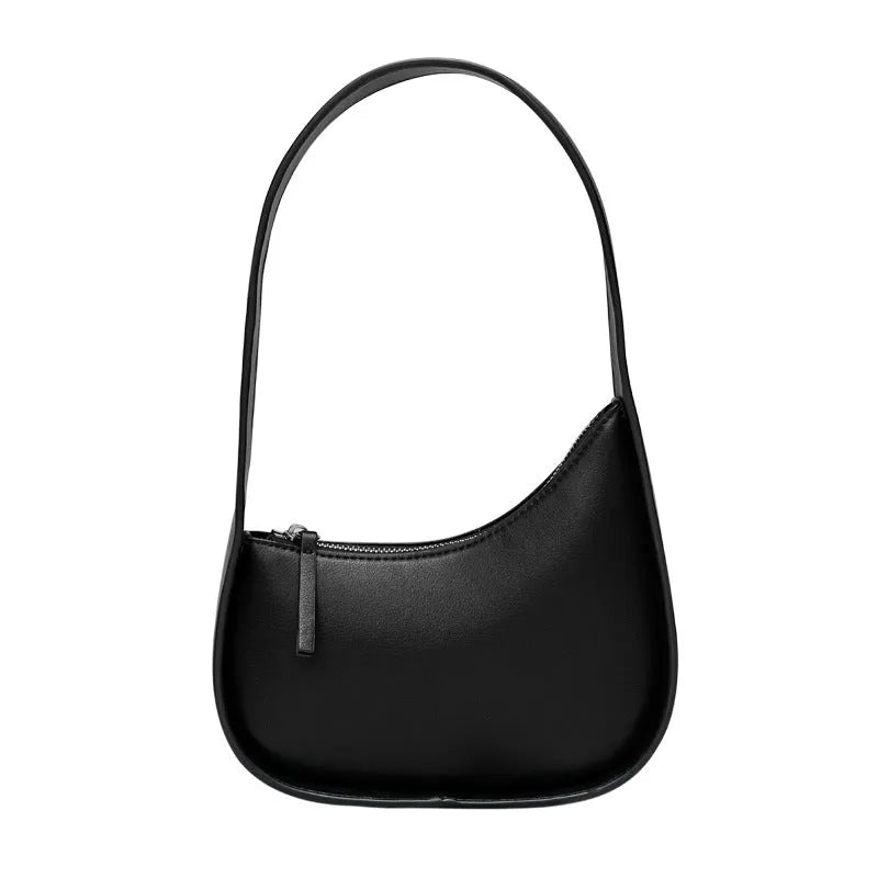 Structured caramel half-moon leather women's shoulder bag with a wide adjustable strap and zip closure.