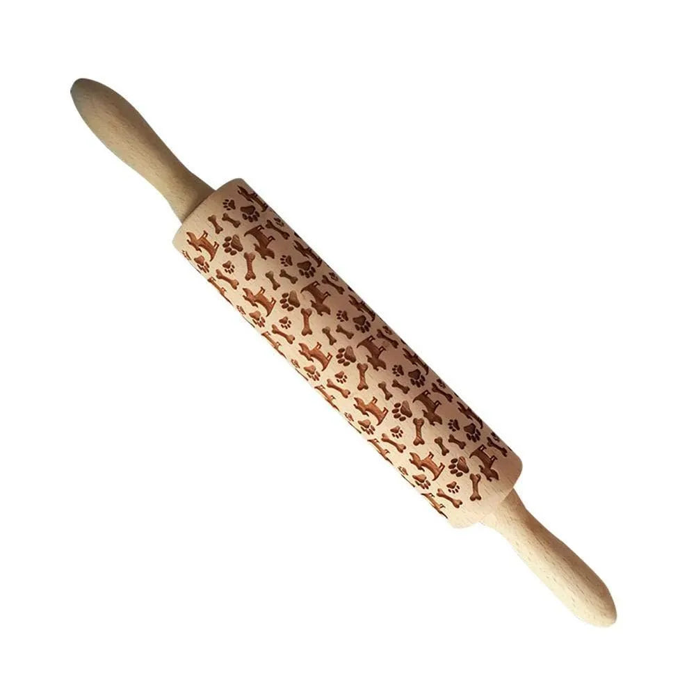 Wooden rolling pin with engraved Christmas patterns including reindeer and snowflakes on a 45cm long barrel.