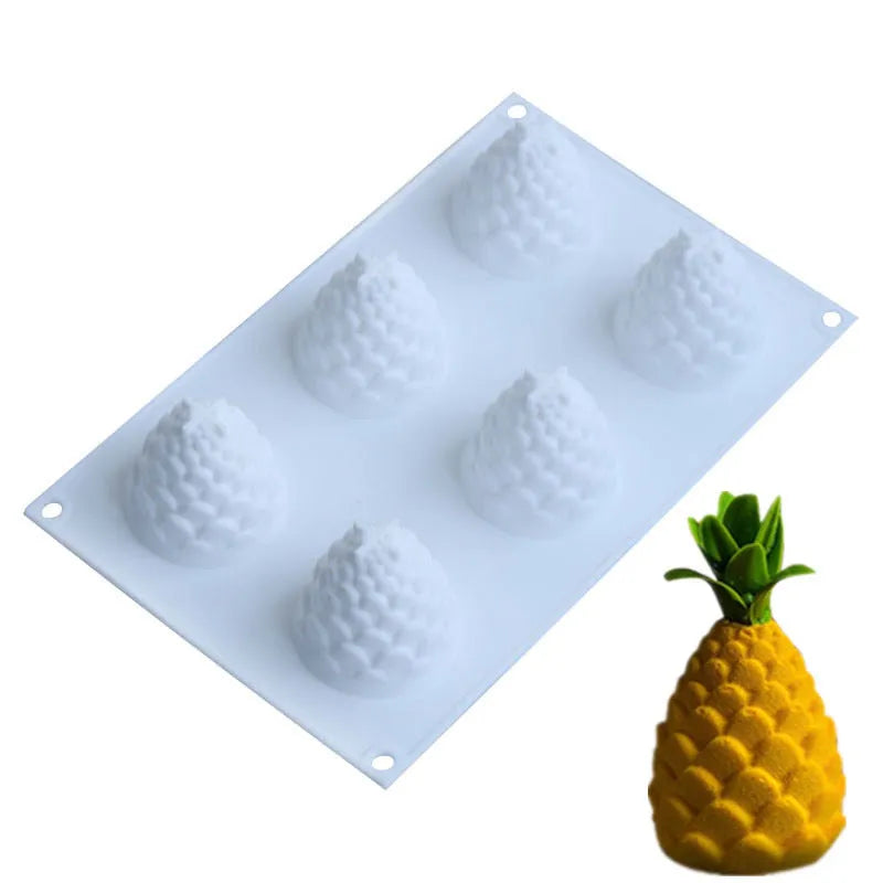 Flexible silicone baking mould with six cavities shaped as pineapples and pine cones for mousse desserts.