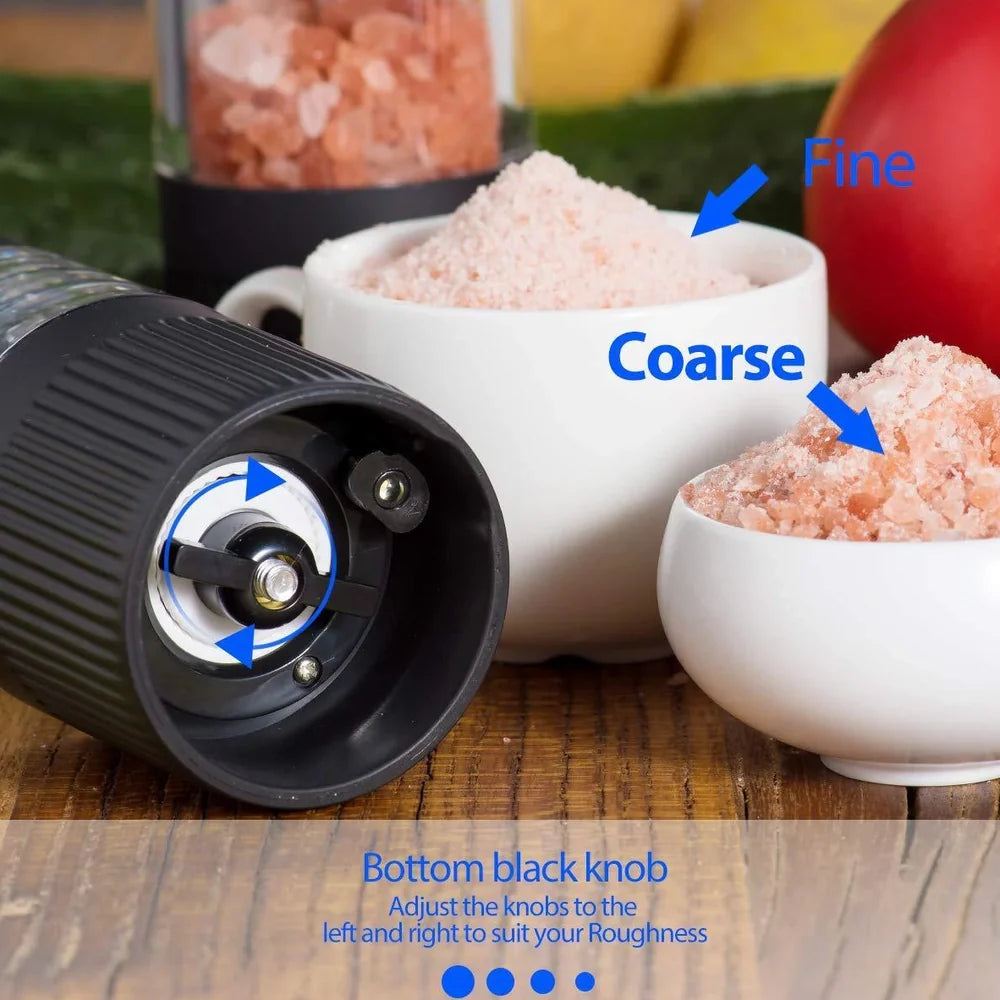 Black electric pepper grinder with transparent section showing peppercorns and ceramic grinding mechanism