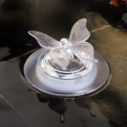 Solar LED float lamp with butterfly design floating on garden pond water surface