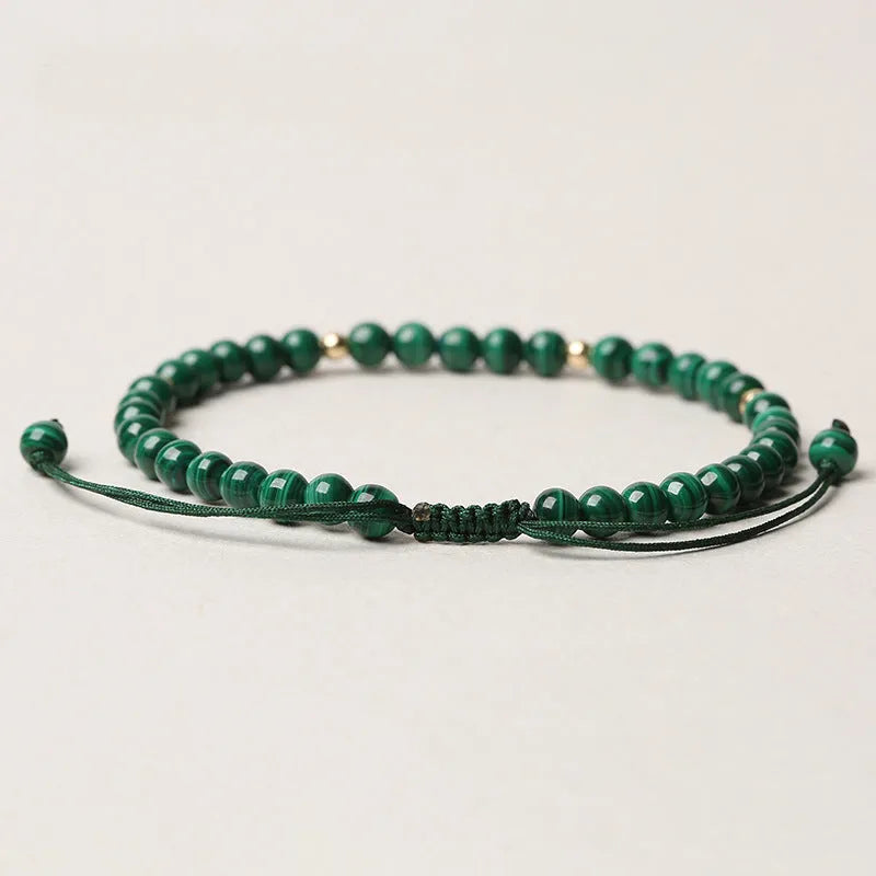 Women's malachite crystal bracelet with golden balls and handwoven design