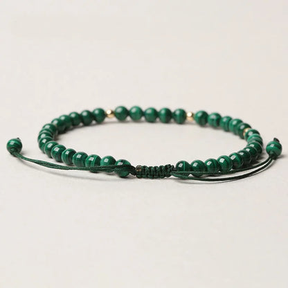 Women's malachite crystal bracelet with golden balls and handwoven design