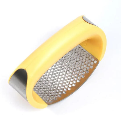 Stainless steel garlic press with ergonomic handle in kitchen setting
