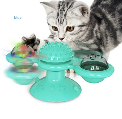 Cat playing with rotating windmill toy featuring suction base and luminous ball