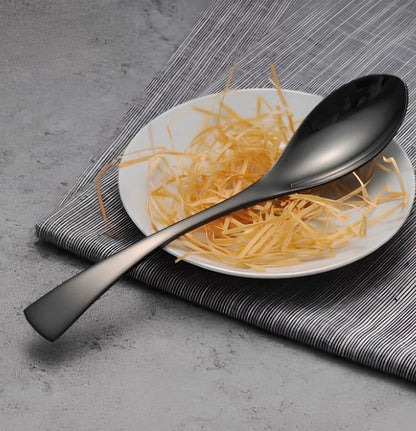 Four-piece black stainless steel cutlery set with mirror polishing showing fork, knife, coffee spoon, and soup spoon