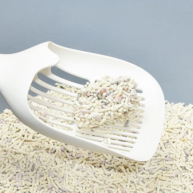 White cat litter shovel with blue detailing, showing large scoop head for pet waste removal