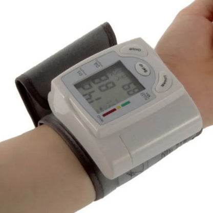 Grey wrist blood pressure monitor with compact design and digital display