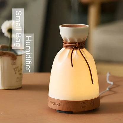 Warm yellow aromatherapy humidifier with beech wood elements and 140ml water tank capacity