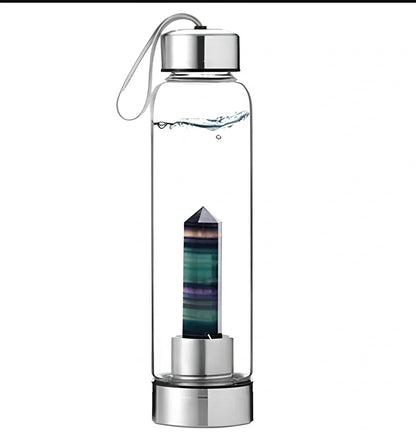 Crystal infused glass water bottle with bamboo lid showing mineral crystal inside 25cm tall container