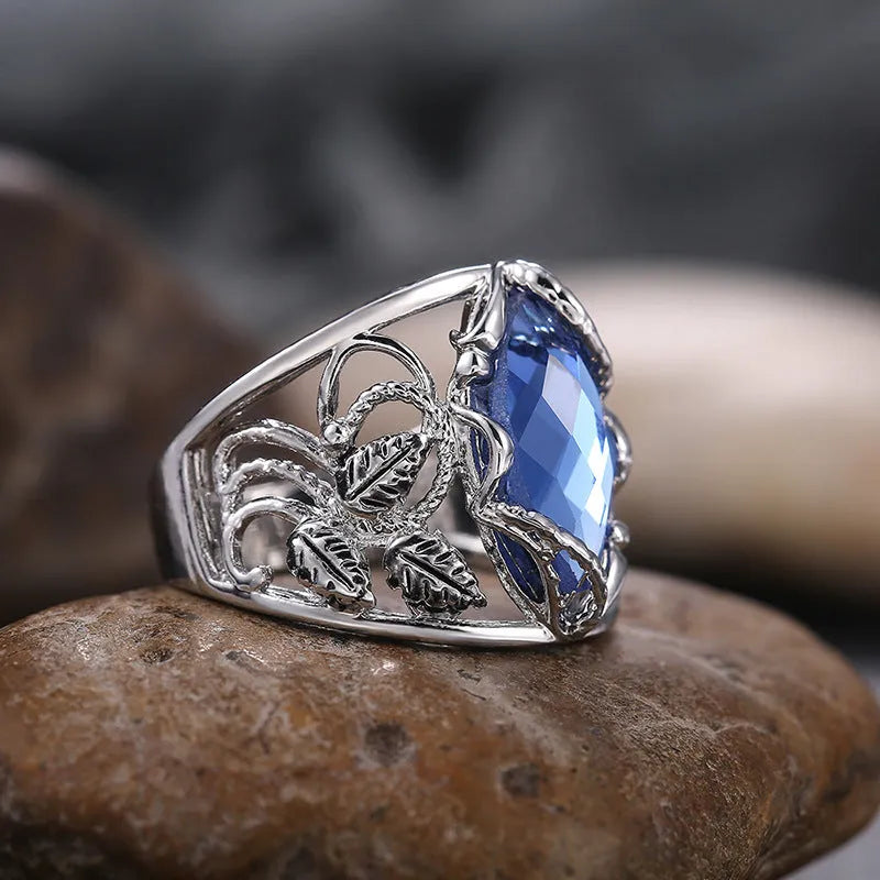 Blue horse eye-shaped women's alloy ring with crystal inlay on a white background.