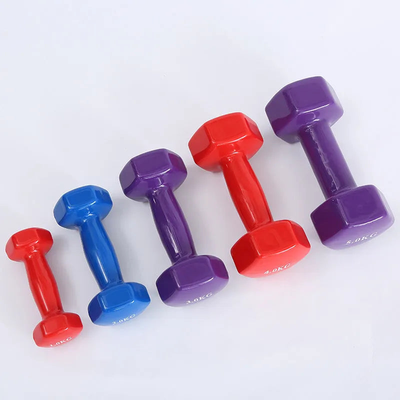 A pair of brightly coloured plastic fitness dumbbells with a glossy surface, shown on a home floor.